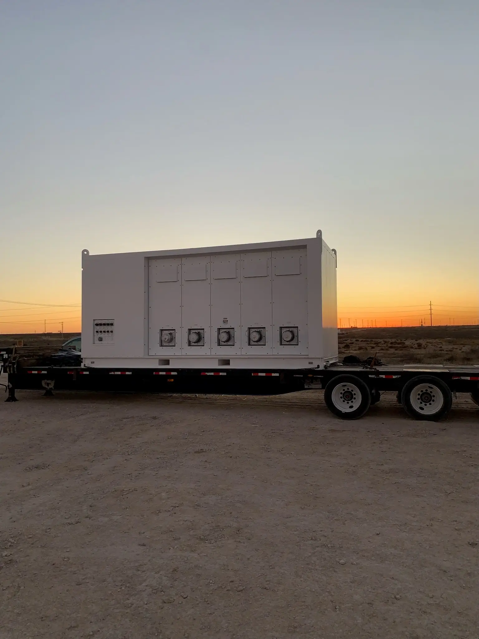 Mobile switchgear substation on a trailer during sunset
